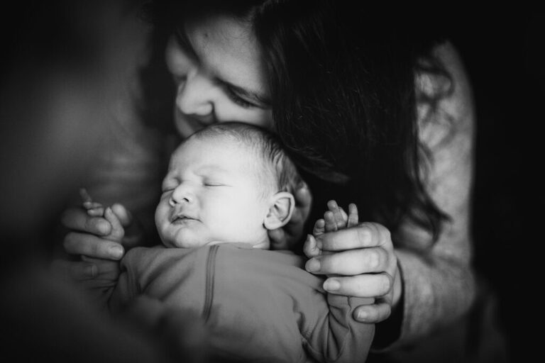mother holds new baby