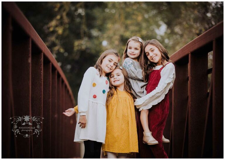 This rustic red bridge was the perfect location for this sweet family picture in Danville, Ca by Nightingale Photography