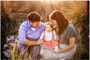 san francisco lifestyle family photographer - family sits together in field