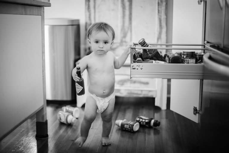 baby in diaper making a mess in the kitchen