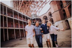 family poses for photos at fort point in san francisco