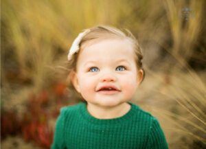 Photo of baby on beach during family photos in Alameda