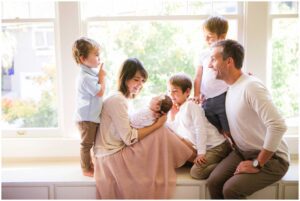 photo of newborn baby at home in oakland with siblings