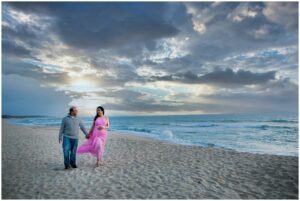 pregnant woman poses on Half Moon Bay beach for maternity photos