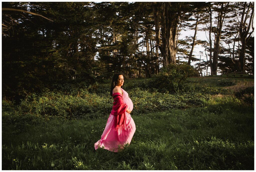 pregnant woman poses on Half Moon Bay beach for maternity photos