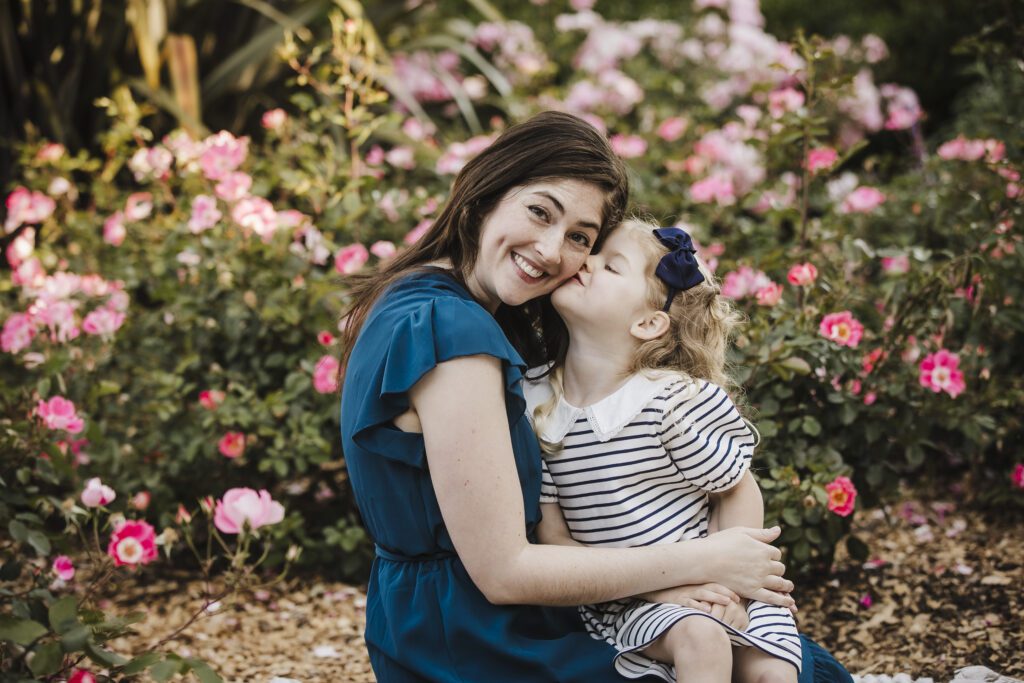 child kisses her mother at Heather Farms Park in Walnut Creek, ca