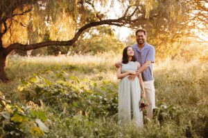 pregnant woman poses in wildflower field during maternity photo session