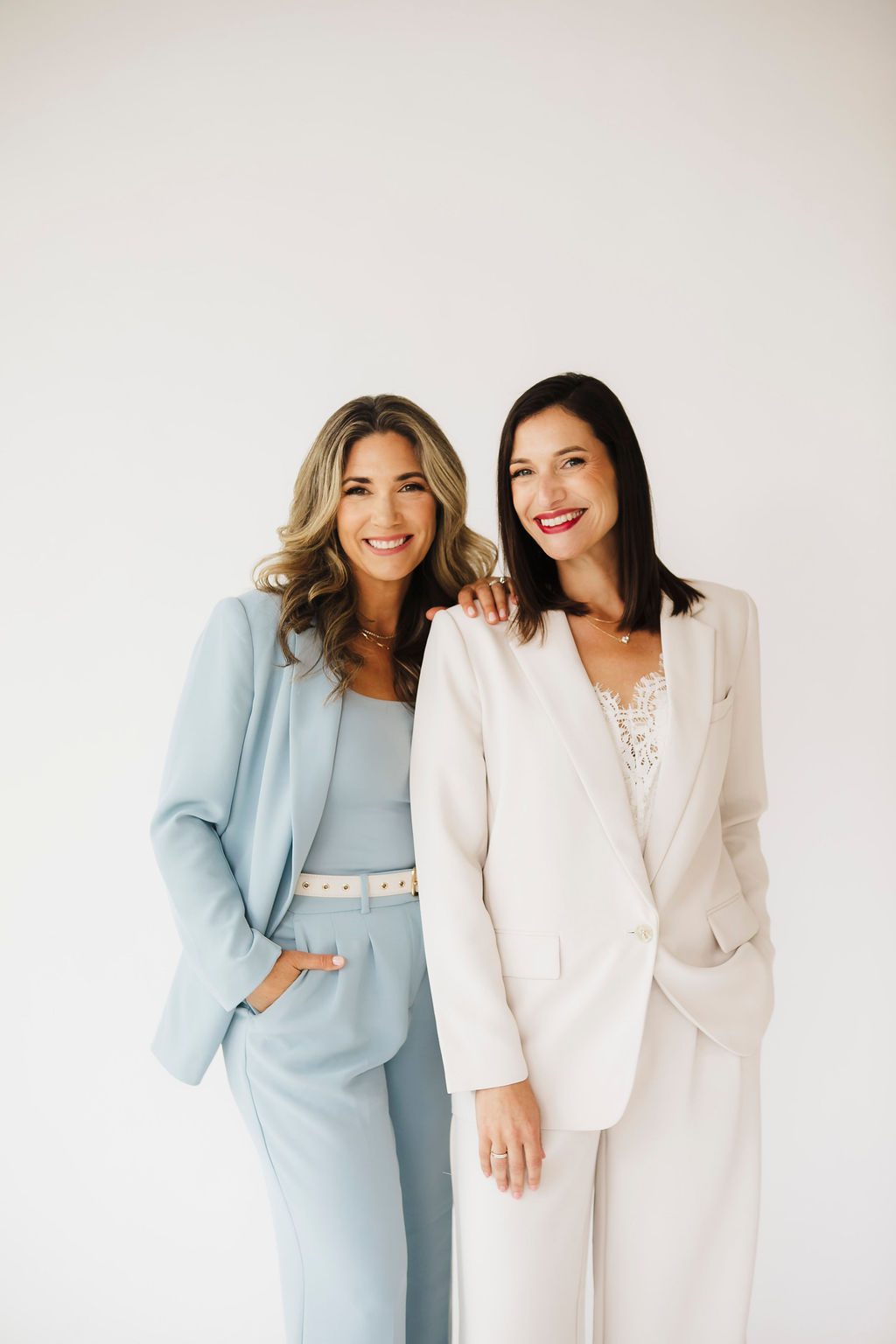 Two business partners smiling together for professional headshots in St. Louis