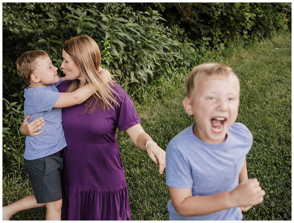 candid photo of young boy running down a green path in st. Louis west county